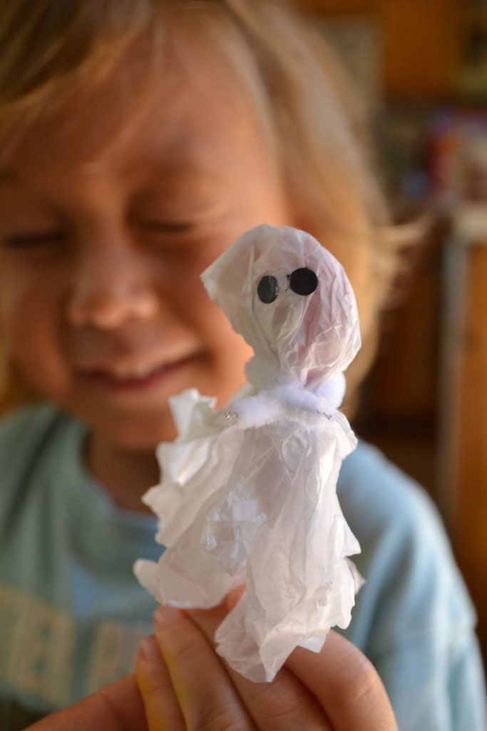 kid holding tissue paper ghost