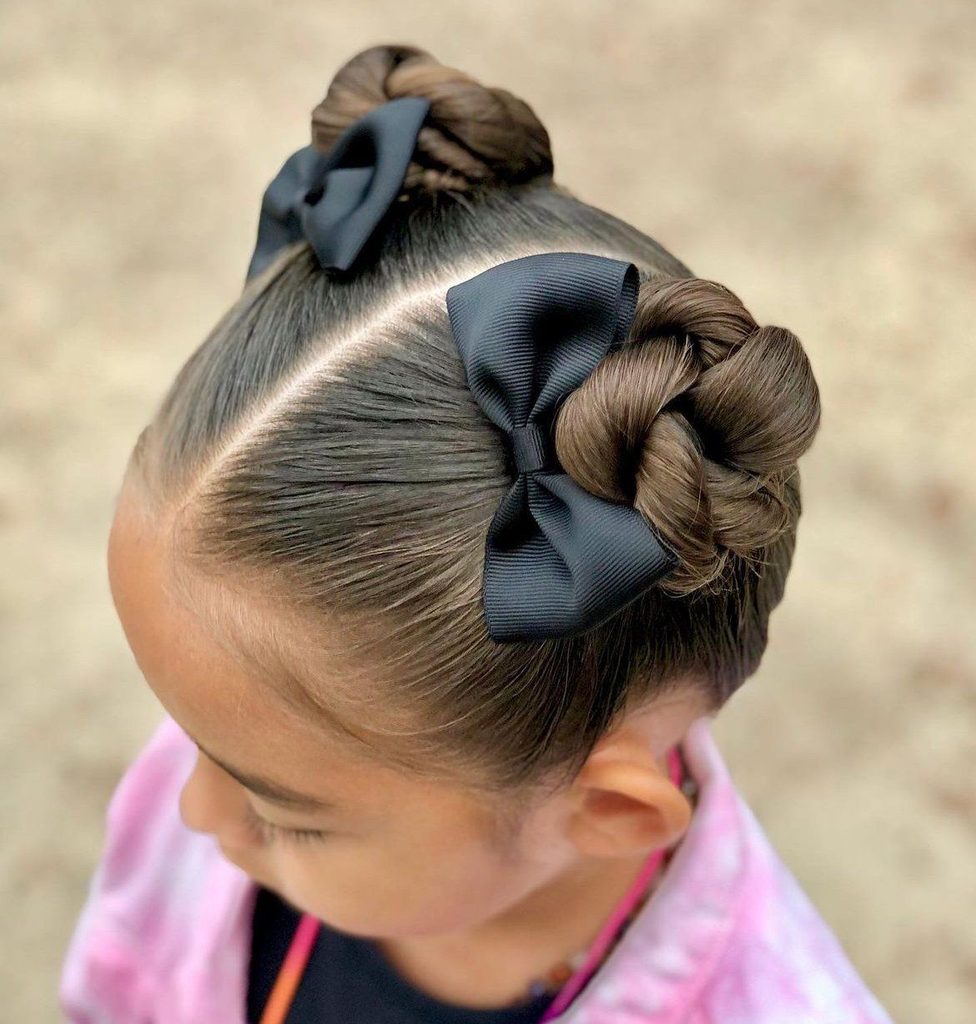 kid with twisted buns