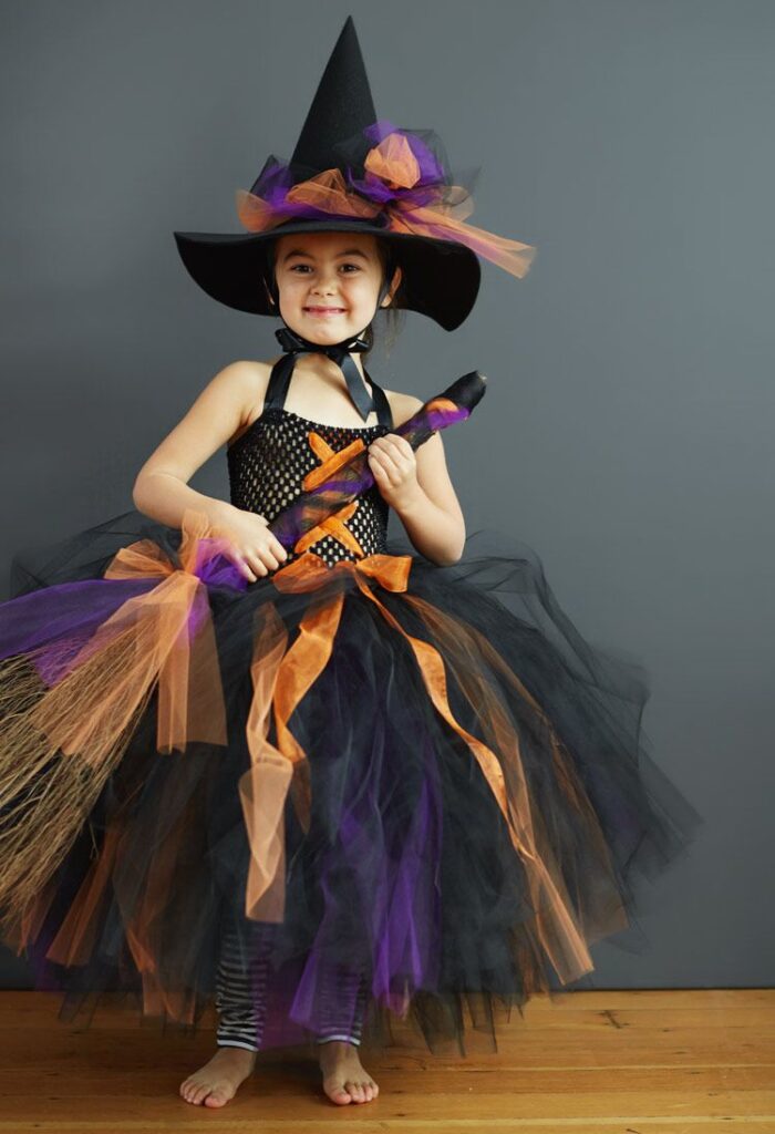 kid in witch costume as one of the halloween costume ideas for kids