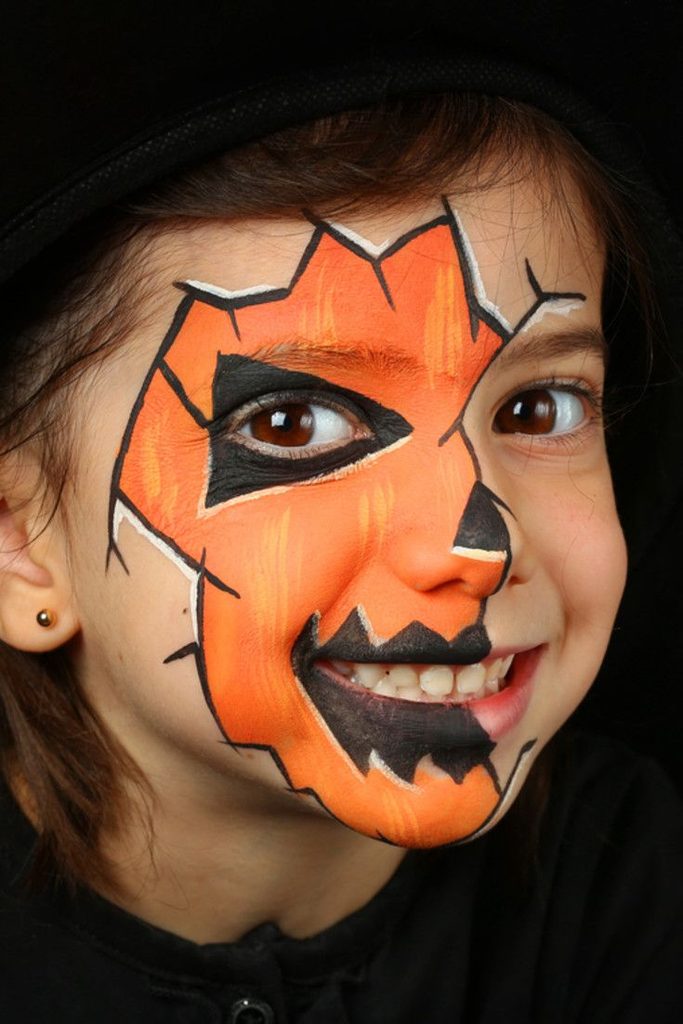 kid with halloween face paint as one of the ways to put together a last minute halloween costume for kids