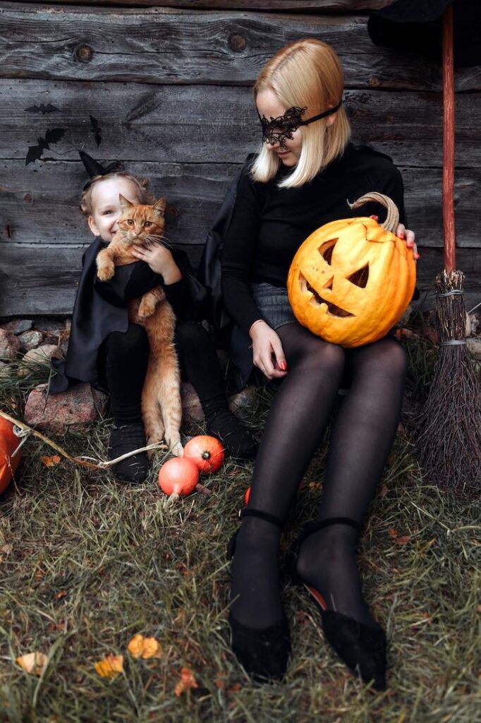 halloween kids with a cat as a way of exploring nocturnal animals as part of halloween learning activities for kids
