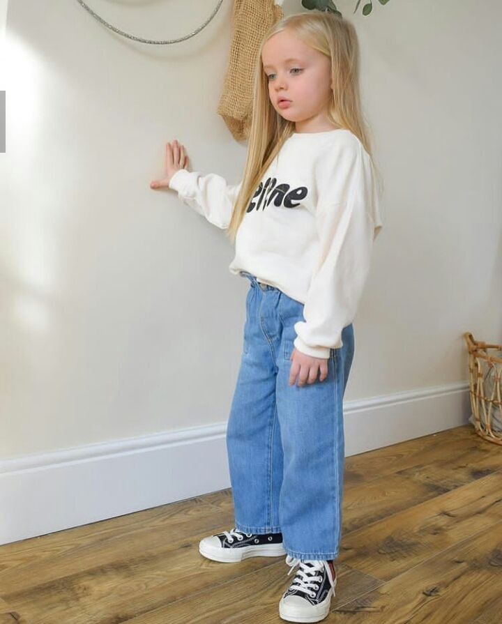 kid in denim and sweater