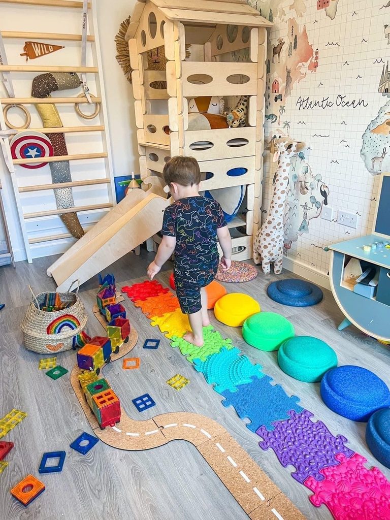 kid in his playroom without too many toys