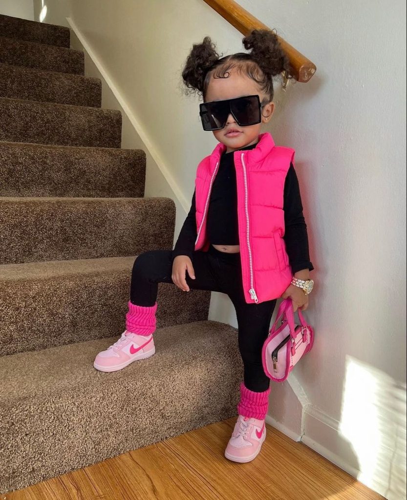 kid in a pink and black outfit