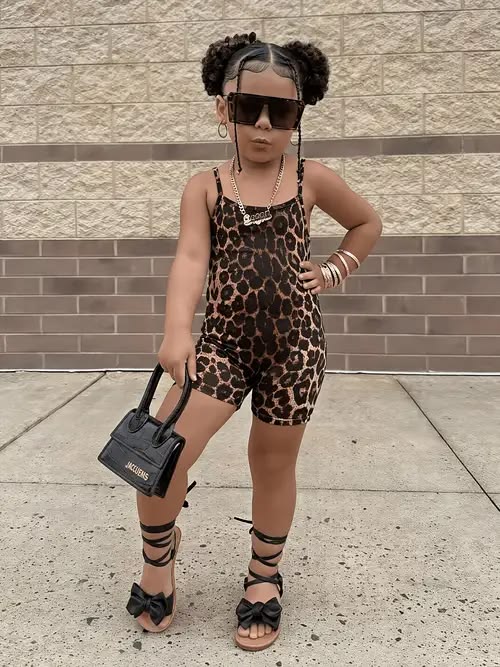 kid in short jumpsuit and sandals