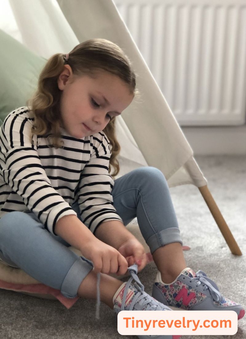kid putting on her shoe
