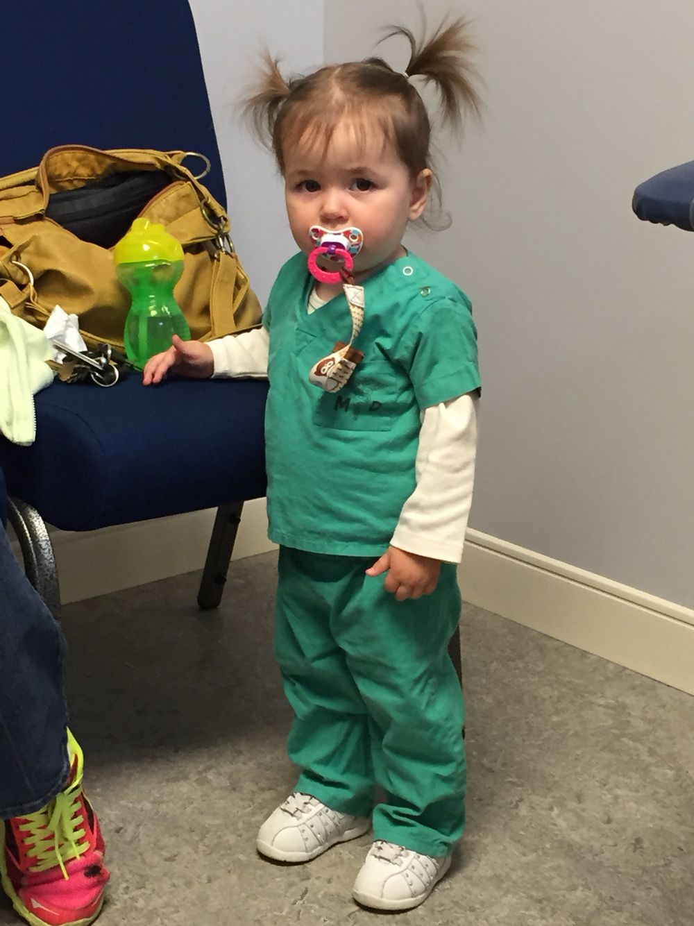 kid wearing long sleeve top under nurse halloween costume