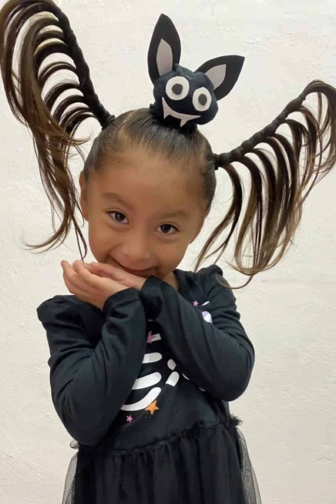 kid with bat hairstyle
