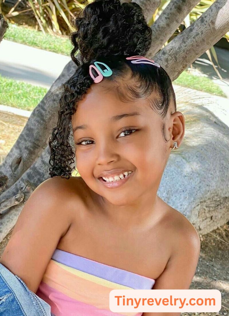 kid with high bun with clips