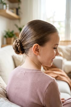 kid with a low bun as protective hairstyles for kids