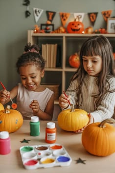 kids painting pumpkin as halloween activity