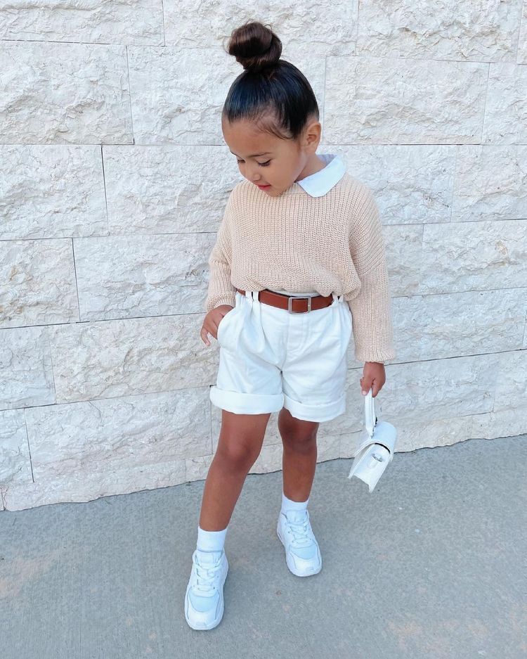 kid in short and knitted sweatshirt
