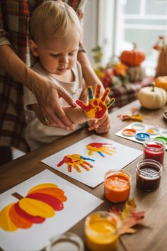 kids making a handprint turkey as Thanksgiving activities for kids