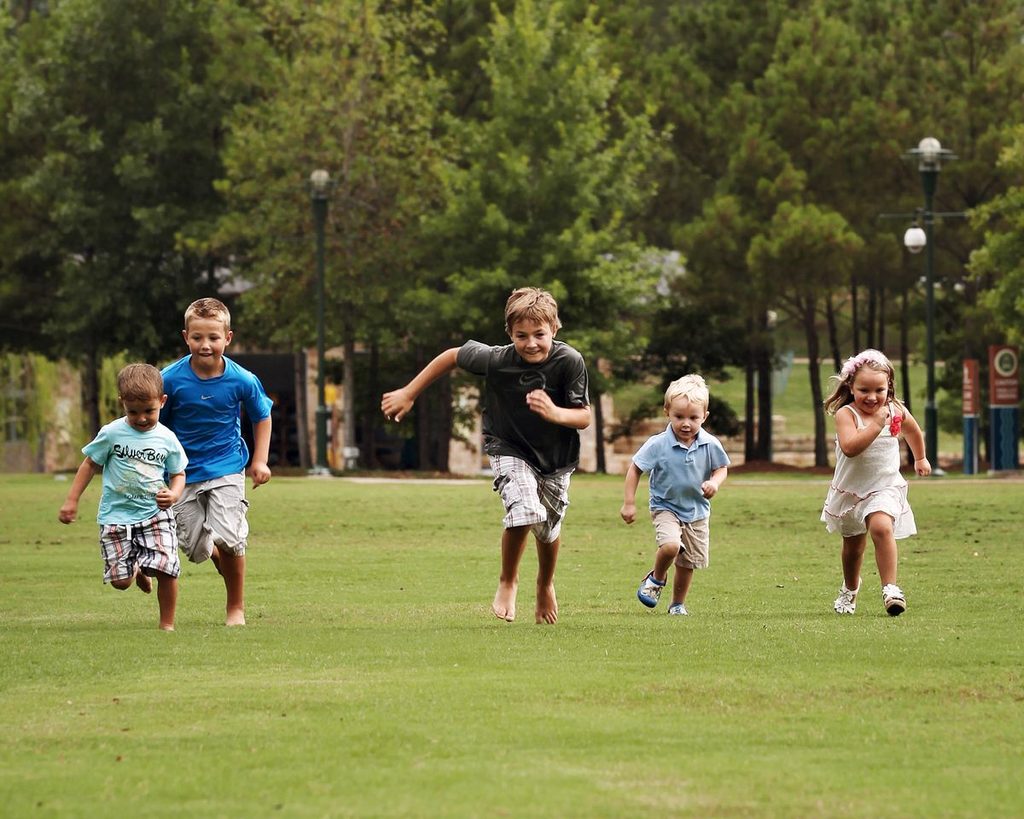 kids running outdoor relay race
