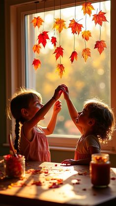 kids decorating home glass wit fall leaves